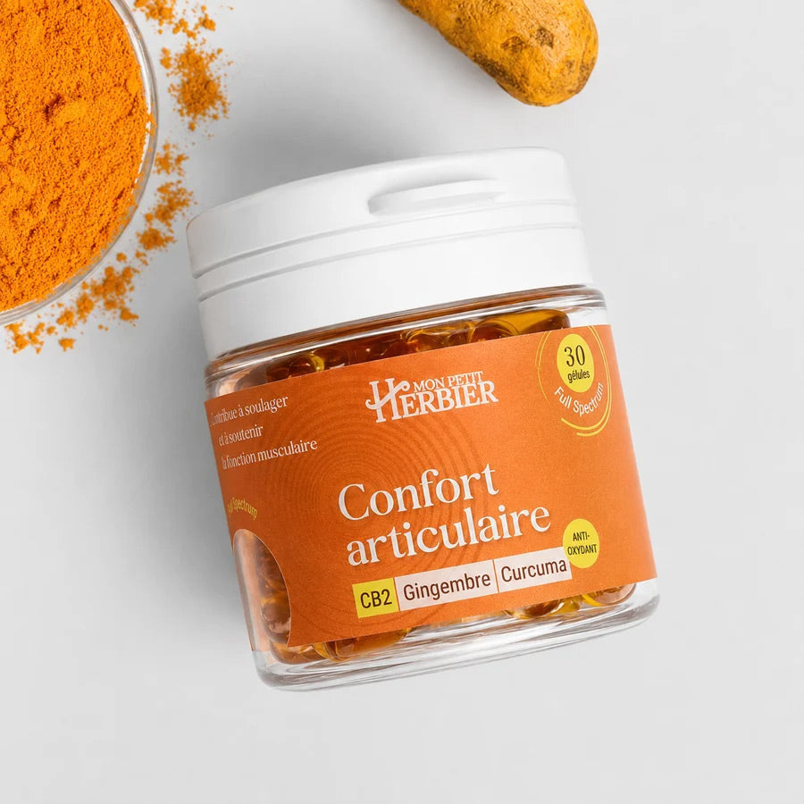 Gélules CB2 Confort articulaire, pot de gélules sur fond de curcuma et de gingembre